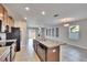 Kitchen with island, granite countertops, and wood cabinets at 6834 Blue Moon Way, Sun City Center, FL 33573