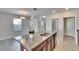 Kitchen island with double sink and views into adjacent dining area at 6834 Blue Moon Way, Sun City Center, FL 33573