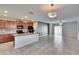 Kitchen with island, granite countertops, and dark cabinets at 6834 Blue Moon Way, Sun City Center, FL 33573