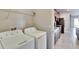 Laundry room with washer, dryer, and kitchen views at 6834 Blue Moon Way, Sun City Center, FL 33573