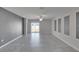 Living room with tile floors, gray accent wall, and natural light at 6834 Blue Moon Way, Sun City Center, FL 33573