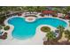 Community pool with lounge chairs and a pergola at 6834 Blue Moon Way, Sun City Center, FL 33573