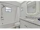 Clean bathroom with white subway tile, granite vanity, and a bathtub at 6950 113Th St, Seminole, FL 33772