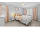 Bright bedroom with a comfortable queen-size bed and soft pink accents at 6950 113Th St, Seminole, FL 33772