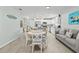 White dining set in open floor plan next to kitchen at 6950 113Th St, Seminole, FL 33772