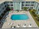 Aerial view of community pool and surrounding patio area at 701 Poinsettia Rd # 302, Belleair, FL 33756