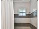 Clean bathroom with shower and tiled walls at 701 Poinsettia Rd # 302, Belleair, FL 33756