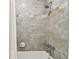 Clean bathroom with a shower/tub combo and grey tile at 701 Poinsettia Rd # 302, Belleair, FL 33756