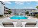 Refreshing community pool with ample lounge chairs at 701 Poinsettia Rd # 302, Belleair, FL 33756