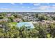 Aerial view showcasing a teal house nestled in a community near the water at 711 Eagle Ln, Apollo Beach, FL 33572