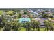 Aerial view of a teal house with a large yard, located in a residential neighborhood at 711 Eagle Ln, Apollo Beach, FL 33572