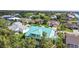 An aerial view of a teal house in a quiet residential neighborhood at 711 Eagle Ln, Apollo Beach, FL 33572