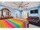 Bedroom with light blue walls and a colorful bedspread at 711 Eagle Ln, Apollo Beach, FL 33572