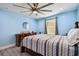 Bedroom with light blue walls, wooden bed frame, and ceiling fan at 711 Eagle Ln, Apollo Beach, FL 33572