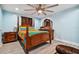 Bedroom with light blue walls and a colorful bedspread at 711 Eagle Ln, Apollo Beach, FL 33572