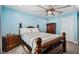 Bedroom with light blue walls, wooden bed frame, and ceiling fan at 711 Eagle Ln, Apollo Beach, FL 33572