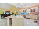 Bright kitchen with white cabinets, marble countertops, and an island at 711 Eagle Ln, Apollo Beach, FL 33572