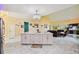 Modern kitchen island with marble countertop and red barstools at 711 Eagle Ln, Apollo Beach, FL 33572