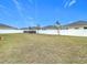 Large backyard with grassy area and a pool in the corner at 7395 Steer Blade Dr, Zephyrhills, FL 33541