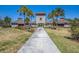 Community center with palm trees and walkway at 7395 Steer Blade Dr, Zephyrhills, FL 33541