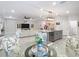 Bright dining area with glass table and floral chairs at 7395 Steer Blade Dr, Zephyrhills, FL 33541