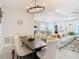 Elegant dining room with farmhouse table and chandelier at 7395 Steer Blade Dr, Zephyrhills, FL 33541