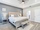 Spacious main bedroom with a large bed and gray accent wall at 7395 Steer Blade Dr, Zephyrhills, FL 33541