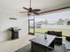 Relaxing screened patio with outdoor furniture and ceiling fan at 7395 Steer Blade Dr, Zephyrhills, FL 33541