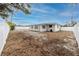 Backyard of the newly renovated house with a white fence and sandy ground at 7449 16Th N St, St Petersburg, FL 33702