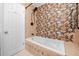 Spa-like bathroom with a jetted tub and designer wallpaper at 7449 16Th N St, St Petersburg, FL 33702