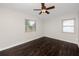 Well lit bedroom featuring dark laminate flooring and ceiling fan at 7449 16Th N St, St Petersburg, FL 33702