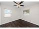 Spacious bedroom with dark laminate wood flooring and ceiling fan at 7449 16Th N St, St Petersburg, FL 33702