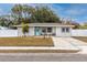 Updated single-story home with new landscaping and a teal front door at 7449 16Th N St, St Petersburg, FL 33702