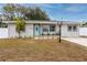 Single story home with light teal front door and landscaped yard at 7449 16Th N St, St Petersburg, FL 33702