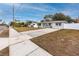 Newly renovated house on a tree-lined street with a large front yard and a white fence at 7449 16Th N St, St Petersburg, FL 33702