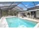 Screened-in pool and patio area with a large pool at 8237 Delaware Dr, Weeki Wachee, FL 34607