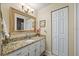 Bathroom with granite countertop, single sink, and a linen closet at 8615 Carroll Oaks Dr, Tampa, FL 33614