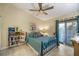 Cozy bedroom with a queen bed, built-in shelving, and access to patio at 8615 Carroll Oaks Dr, Tampa, FL 33614