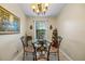 Bright dining area with glass table and four chairs at 8615 Carroll Oaks Dr, Tampa, FL 33614