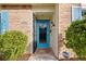 Front entry with teal door and Ring doorbell at 8615 Carroll Oaks Dr, Tampa, FL 33614