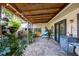 Covered patio with hanging chair and potted plants at 8615 Carroll Oaks Dr, Tampa, FL 33614