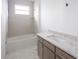 Bathroom with soaking tub, gray vanity, and marble-style floor at 9057 Bantry Bay Blvd, Englewood, FL 34224