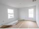 Unfinished bedroom with two windows and brown paper floor covering at 9057 Bantry Bay Blvd, Englewood, FL 34224