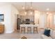 Modern kitchen with island, gray cabinets, and tile floor at 9057 Bantry Bay Blvd, Englewood, FL 34224