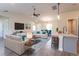 Living room with sectional sofa, coffee table, and vaulted ceiling at 9057 Bantry Bay Blvd, Englewood, FL 34224