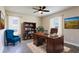 Home office with wooden desk, blue chair, and built-in shelves at 9057 Bantry Bay Blvd, Englewood, FL 34224