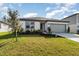 Landscaped lawn and a gray garage door add to the curb appeal of this one story home at 9215 Royal River Cir, Parrish, FL 34219