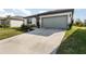 One story home with gray garage door and a wide driveway.Landscaped lawn at 9215 Royal River Cir, Parrish, FL 34219