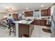 Kitchen with island, dark wood cabinets, and stainless steel appliances at 9215 Royal River Cir, Parrish, FL 34219