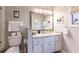 Bathroom features granite countertop, white cabinets, and a large mirror at 1018 Caravel Ct, Tarpon Springs, FL 34689